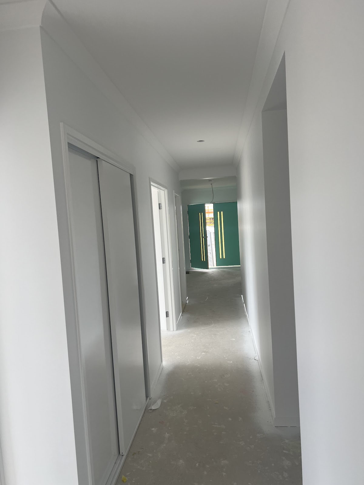 Long hallway in a new home freshly painted white